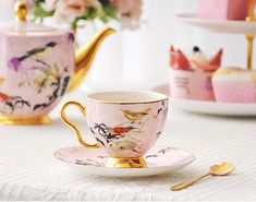 tea cups and saucers with birds on them