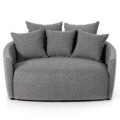 a grey chair with pillows on it