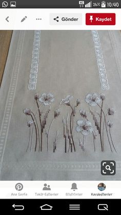 an embroidered table runner with flowers on it