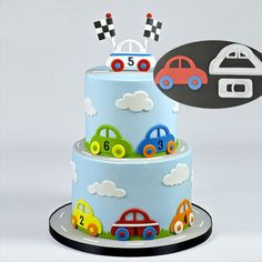 a three tiered cake with cars and numbers on the top is decorated in blue frosting