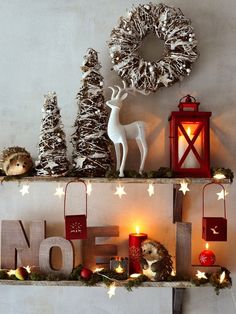 two shelves with christmas decorations and lights on them, one shelf is decorated with pine cones