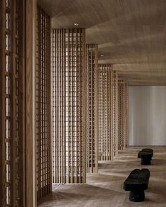 an empty room with wooden slats and benches