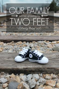 two shoes sitting on top of train tracks with the words our family will be growing by two feet coming may 2013