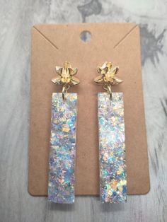 the earrings are made out of white and gold foil