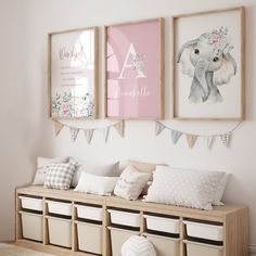 three framed pictures hang on the wall above a wooden bench with storage bins underneath