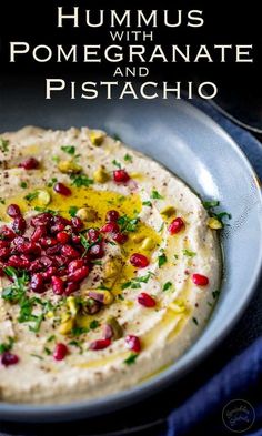 hummus with pomegranate and pistachio in a bowl