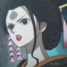 an animated image of a woman with black hair and pink flowers in her hair, looking at the camera