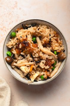 a bowl filled with rice and vegetables on top of a table