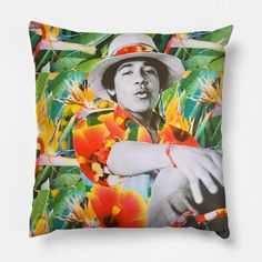 a pillow with a photo of elvis presley on it and flowers in the back ground