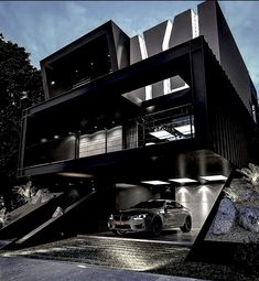 a car is parked in front of a black building with stairs leading up to it