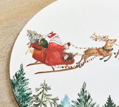 a christmas plate with santa riding in a sleigh