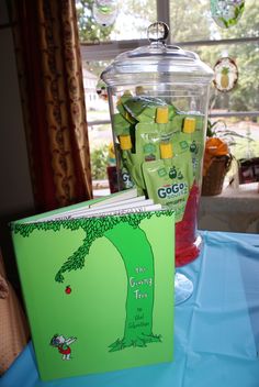 there is a green book and a blender on the table next to each other