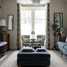 a living room with two couches and a coffee table in front of a window