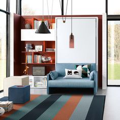 a living room filled with lots of furniture and bookshelves on top of each other