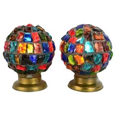 two colorful glass balls sitting on top of each other