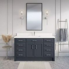 a bathroom vanity with a mirror above it and a rug on the floor next to it