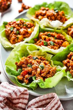 lettuce wraps filled with meat and vegetables on a plate