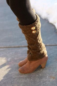 a woman's legs wearing boots and leg warmers with buttons on the side