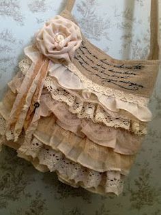 a handbag hanging on the wall with lace and fabric ruffles around it