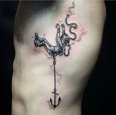 a man with an anchor tattoo on his chest is holding onto the rope that he has tied to