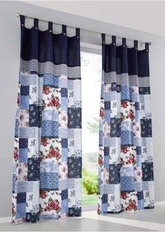 a window with blue and white patchwork curtains