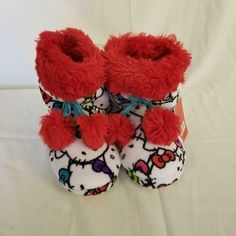 These cute little booties are purrfect for your little one. White with Hello Kitty all over, red shag on top, red pom-poms and rubber sole. These are NEW WITH TAGS and were originally priced at $26. This and all items we sell come from a smoke free, pet free and peanut free environment. We ship only to the buyer's registered eBay and PayPal shipping address. Hellokitty Shoes, Hello Kitty Boots, Hello Kitty Slippers, Kitty House, Red Pom Poms, Boot Slippers, Hello Kitty Merchandise, Hello Kitty Shoes, Hello Kitty House