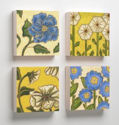 four square paintings with blue and yellow flowers painted on them, all in different colors