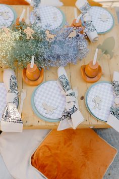 the table is set with place settings and napkins