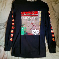 a black long sleeve shirt with japanese writing on it