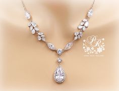 This sparkling bridal necklace and earrings created with Rhinestone, 25mm Zirconia teardrop and finished off with lobster clasp. This gorgeous jewelry set will look elegant and beautiful quality on any classic or vintage inspired bride! Wonderful gift for both a loved one and yourself. All zirconia shines a lot! Finish: Silver Platinum plated components Material: Top quality rhinestones, AAA Zirconia, lobster clasp. Length of Necklace: 17.5 inches and 2 inches extender. Length of Earrings: 2 3/4 Elegant Teardrop Bridal Necklace For Anniversary, Wedding Jewelry Sets With Cubic Zirconia In Drop Shape, Teardrop Bridal Necklace With Matching Earrings, Wedding Cubic Zirconia Dangle Drop Necklace, Teardrop Cubic Zirconia Bridal Necklace For Anniversary, Teardrop Bridal Necklace In Cubic Zirconia, Cubic Zirconia Dangle Drop Necklace For Wedding, Anniversary Teardrop Cubic Zirconia Bridal Necklace, Wedding Pear-shaped Jewelry With Sparkling Stones