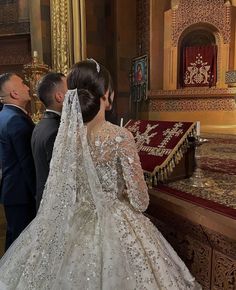 the bride and groom are looking at the alter