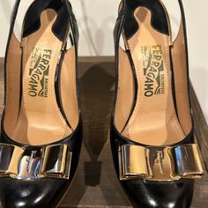 Excellent Condition. Beautiful Gold Toned Metal Bows. They Have Slight Wear At Sole, One Heel Has A Small Scratch. Otherwise In Mint Condition. They Have No Box Or Dust Bag. Size 7 Salvatore Ferragamo Shoes, Slingback Heel, Gold Tone Metal, Mint Condition, Salvatore Ferragamo, Shoes Women Heels, Dust Bag, Shoes Heels, Black Leather