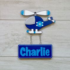 a blue and white sign with a helicopter on it's side that says charlie