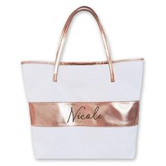 a white and rose gold purse with the name nicole on it's front pocket