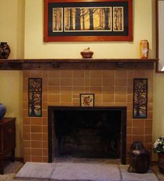 a living room with a fire place and paintings on the wall