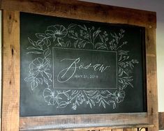 a chalkboard with the name ava written on it in front of a wooden frame