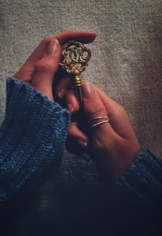 a person holding an ornate key in their hand