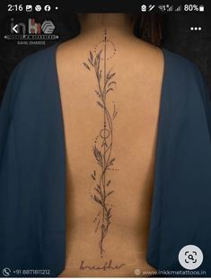 the back of a woman's body with tattoos on her upper and lower back