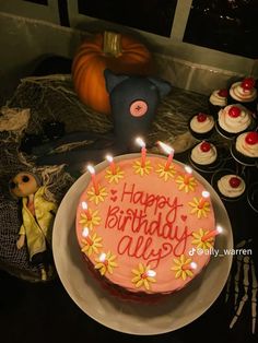 a birthday cake with candles and decorations on a table