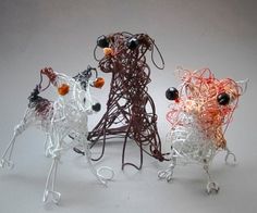 three small wire sculptures made to look like animals