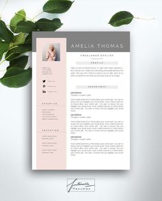 a pink and gray resume template on top of a white table with green leaves in the background