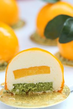 an orange dessert on a gold plate with leaves