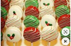 there are many candy lollipops on the table with green and red stripes