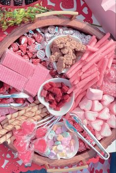 a wooden tray filled with lots of candy and candies