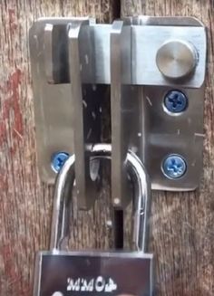 a close up of a padlock on a wooden door