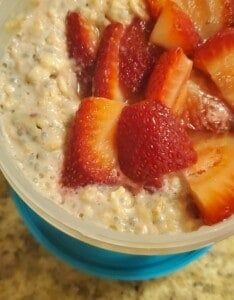 a bowl of oatmeal with strawberries on top