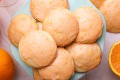 some oranges and muffins are on a blue plate