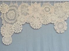 there are many doily hanging on the clothes line