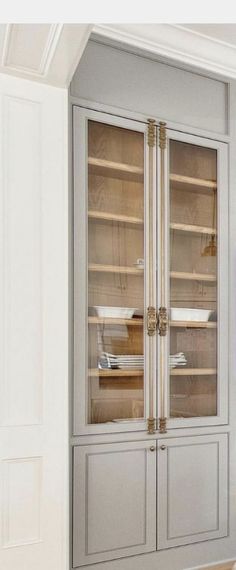 a large glass door cabinet in a room