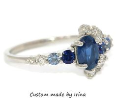 This Enchanting Ring features an oval shape 1.2 carat Blue Sapphire. Flanked by .30 carat 2 shiny deep blue sapphires, .20 carat aqua color 2 sapphires, .40 carat 7 Ice Gray Diamonds. Set in 14k white gold. Can be custom made in rose or yellow or white gold. Please choose the gold color at checkout. OOAK (one-of-a-kind) ring makes you the owner of something that nobody else has. Find your true style! Own this ring! Ethical Sourcing: This ring has a natural, ethically-sourced stones and recycled Blue Sapphire Ring With Marquise Cut Center Stone, Marquise Cut Blue Sapphire Ring, Blue Oval Sapphire Ring With Prong Setting, Oval Blue Tanzanite Sapphire Ring, Heirloom Blue Sapphire Diamond Ring, Oval Blue Multi-stone Sapphire Ring, Blue Marquise Sapphire Ring For Promise, Blue Marquise Sapphire Promise Ring, Blue Sapphire Marquise Ring For Promise